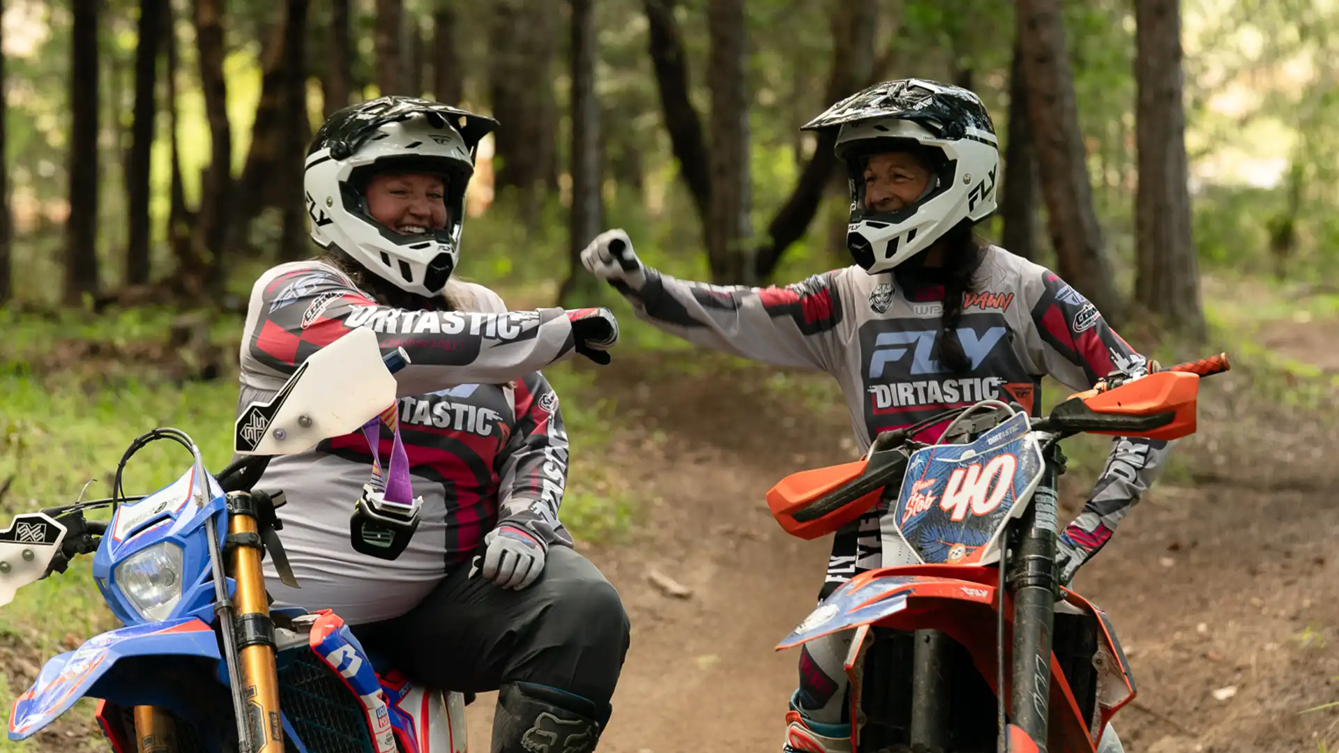 Woman learning to ride a dirt bike at a beginner clinic